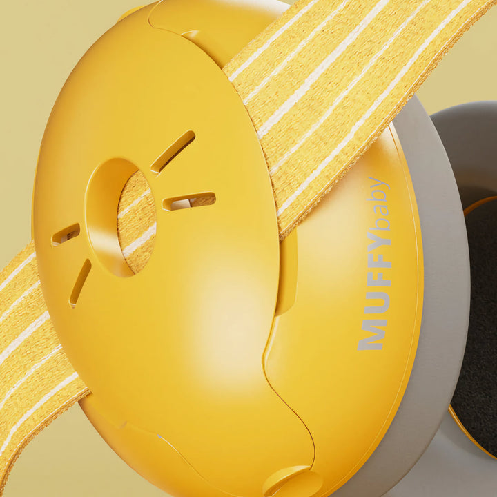 Close-up of Alpine Muffy Baby Earmuffs in yellow, showing the durable ear cup design and adjustable non-slip headband for comfortable infant hearing protection.