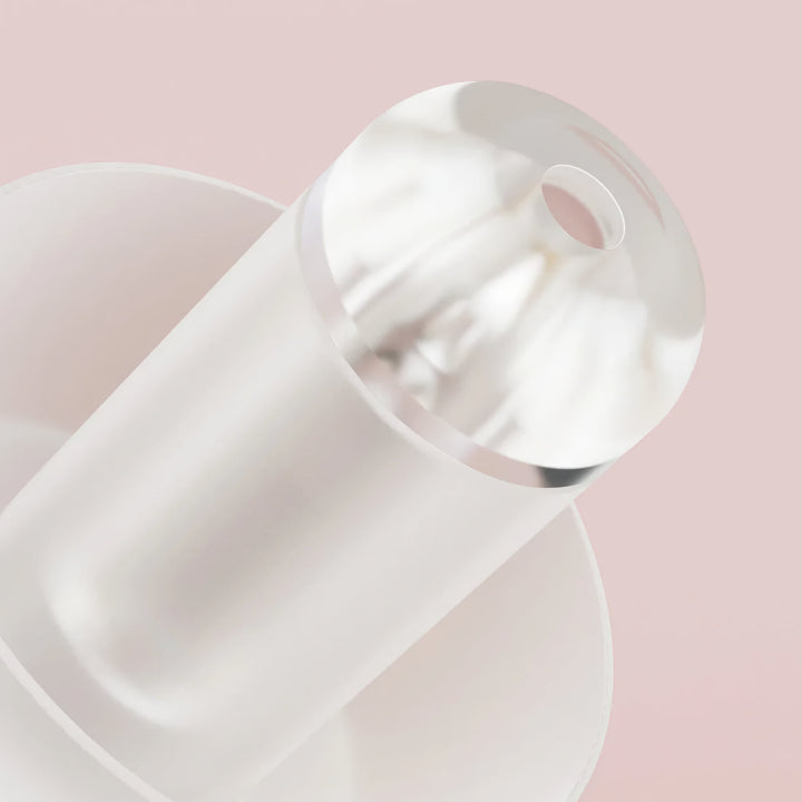 Macro close-up of Alpine PartyPlug Earplugs' acoustic filter, highlighting its transparent design for high-fidelity noise reduction.