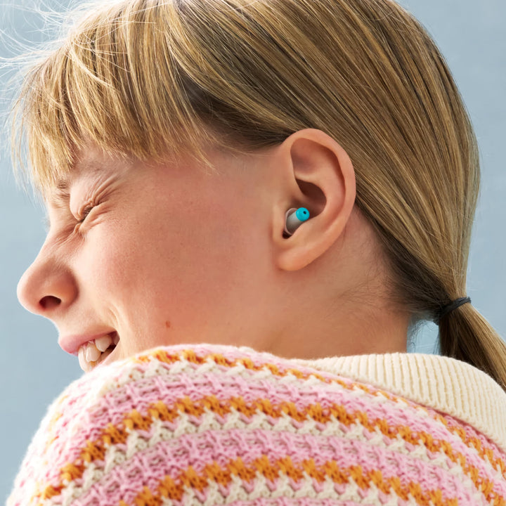 Child wearing Alpine Pluggies Kids Earplugs, designed for noise reduction, hearing protection, and a comfortable fit for children.