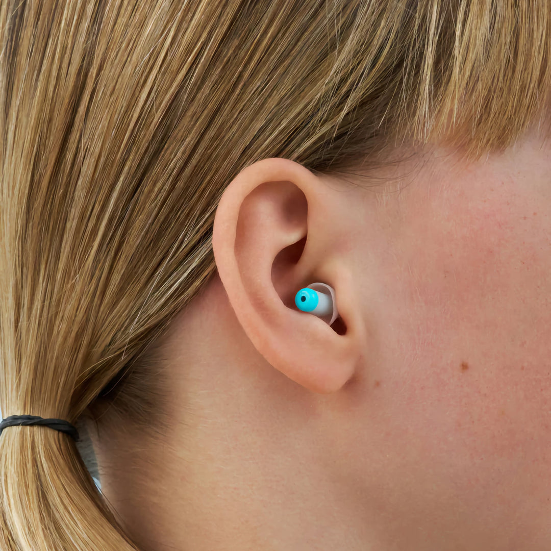 Side view of child wearing Alpine Pluggies Kids Earplugs, designed for secure fit, noise reduction, and hearing protection.