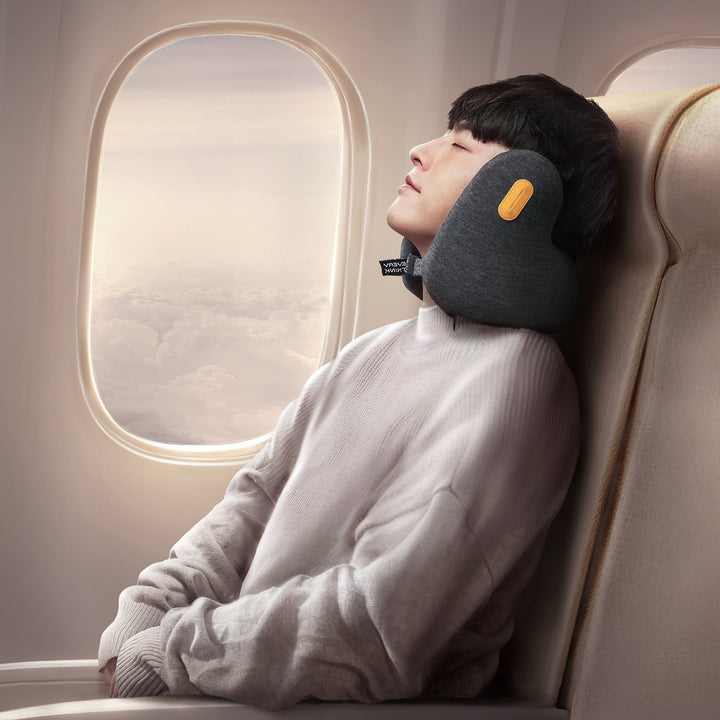 Man using EVERYTHINK E2 dark gray travel neck pillow on airplane for comfortable in-flight sleep