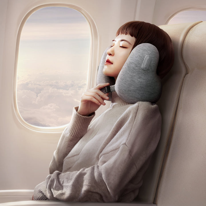 Woman using EVERYTHINK E2 light gray travel neck pillow for comfortable sleep on airplane seat