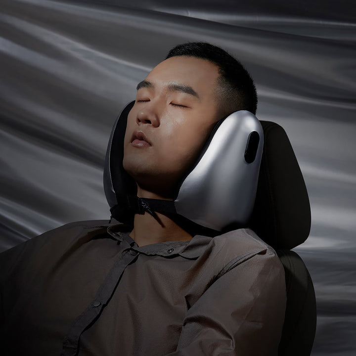 Man sleeping with EVERYTHINK E2-X metallic silver travel neck pillow on a car seat