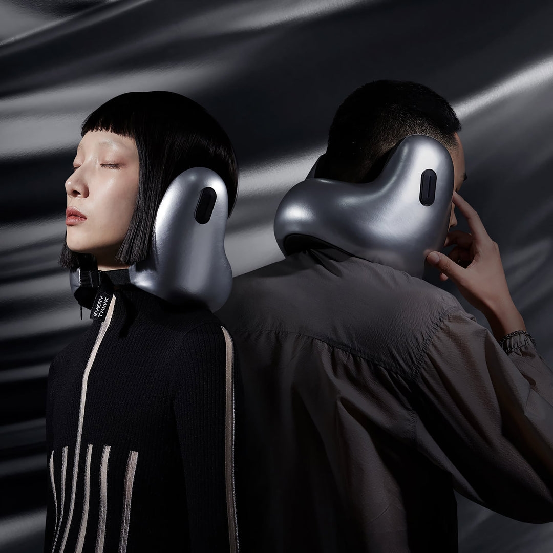 Man and woman wearing EVERYTHINK E2 X travel neck pillows in metallic silver, side-by-side view