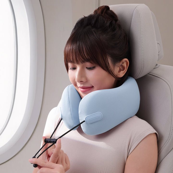 Woman adjusting EVERYTHINK EC3 neck pillow in Clear Sky Blue for a perfect fit during flight