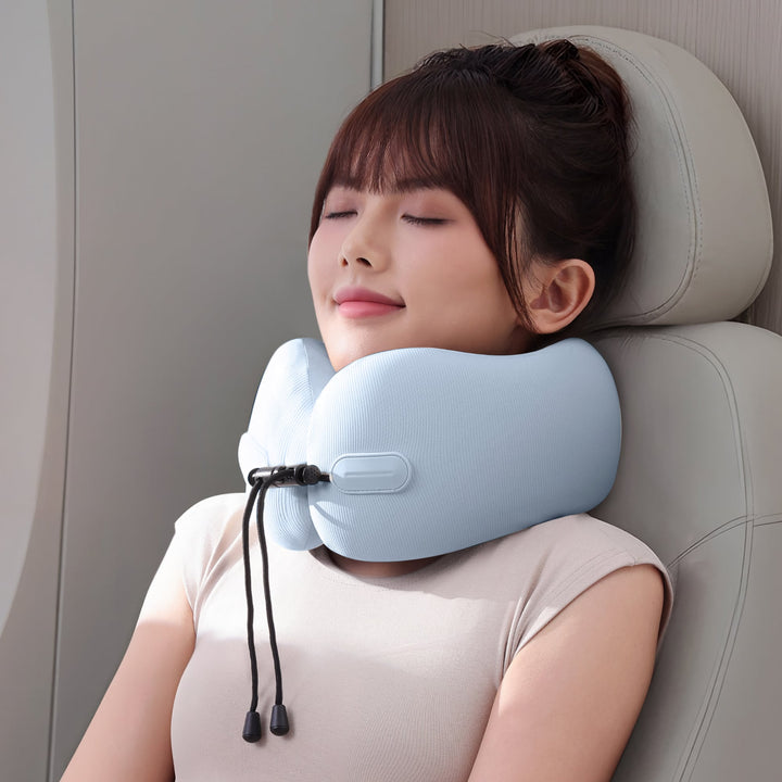 Woman using EVERYTHINK EC3 neck pillow in Clear Sky Blue while resting on a plane seat