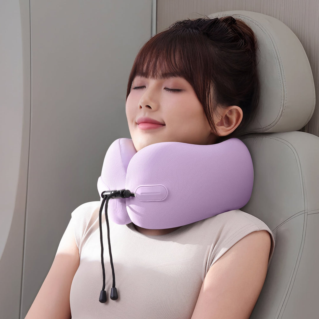 Woman using EVERYTHINK EC3 foldable neck pillow in Lavender Mist for travel comfort on a plane seat