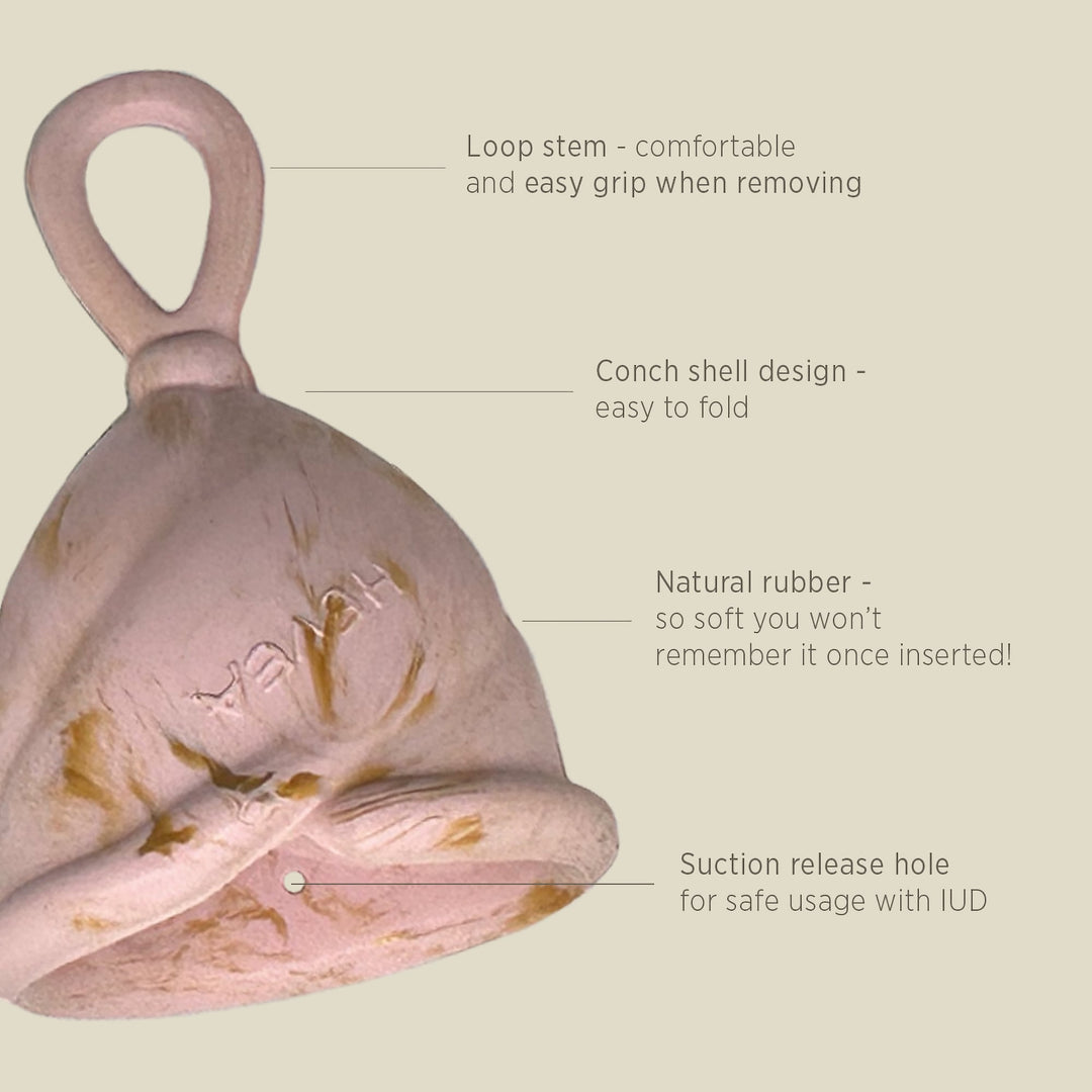 Close-up of Hevea Loop Cup showing loop stem, conch shell design, suction hole, and soft natural rubber material