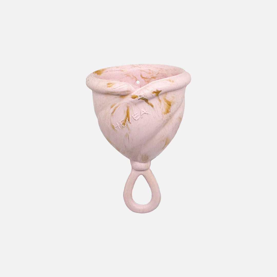 Hevea Loop Menstrual Cup in Size 1, Golden Blush color, made from soft natural rubber with loop stem for easy removal