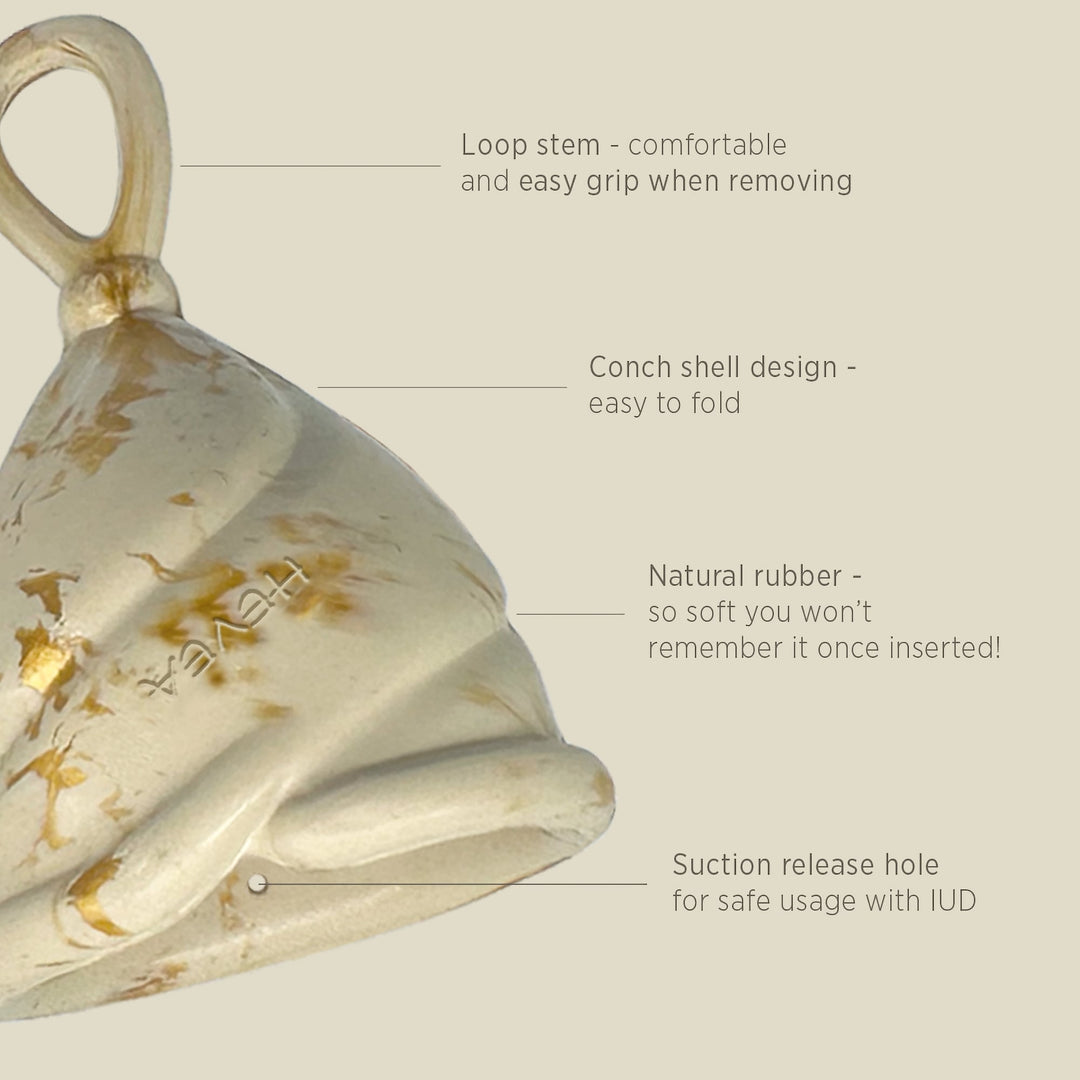 Close-up of Hevea Loop Cup Size 2 in Golden Sand showing loop stem, soft rubber, conch design, and suction release hole