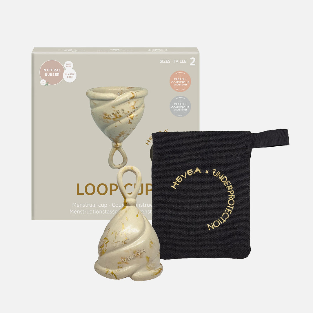 Hevea Loop Menstrual Cup Size 2 in Golden Sand with packaging and black storage pouch, made from natural rubber