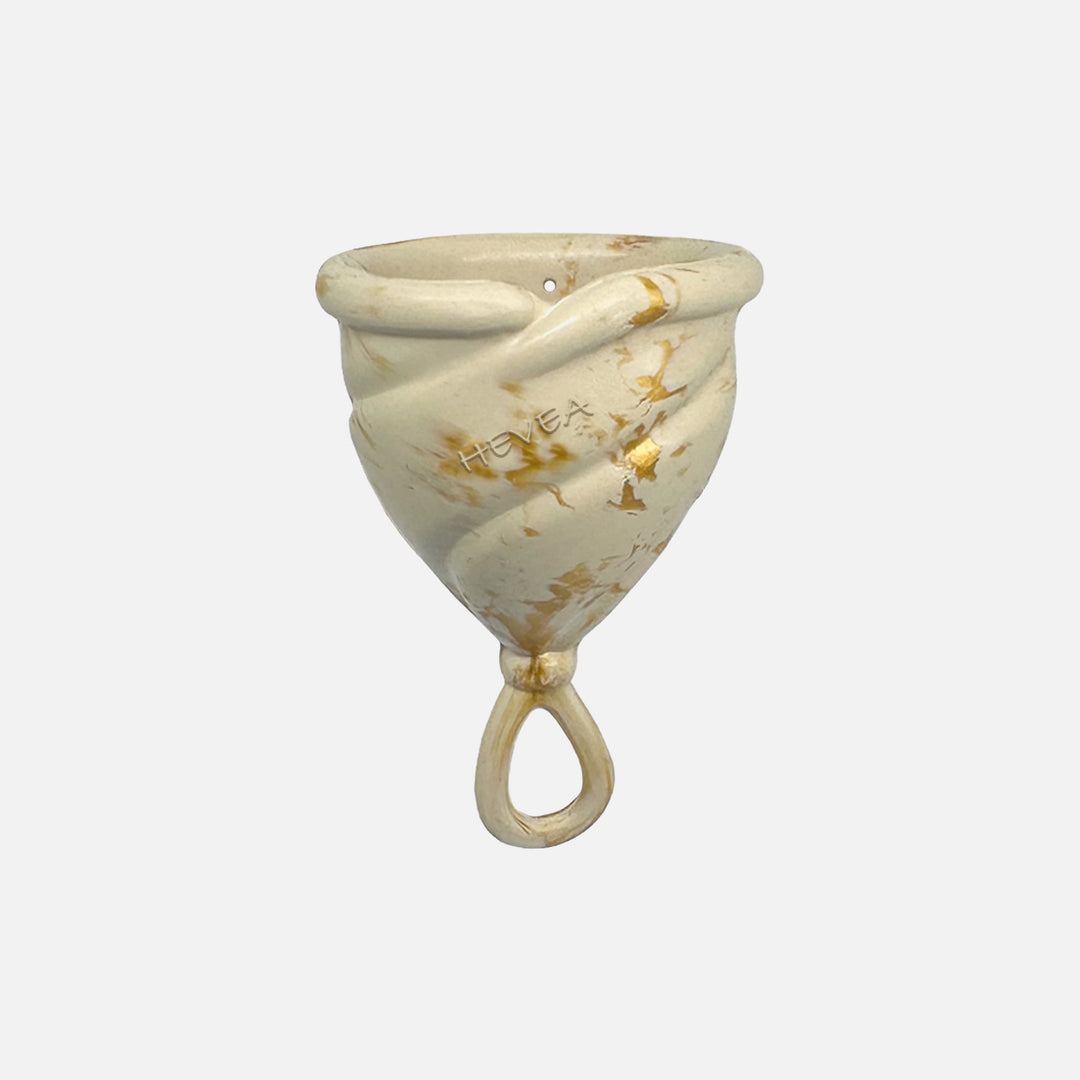 Hevea Loop Menstrual Cup in Size 2, Golden Sand color, made from soft natural rubber with loop stem for easy removal
