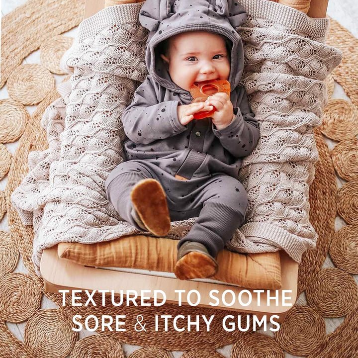 Baby chewing HEVEA Panda Teether with textured natural rubber surface to soothe sore and itchy gums