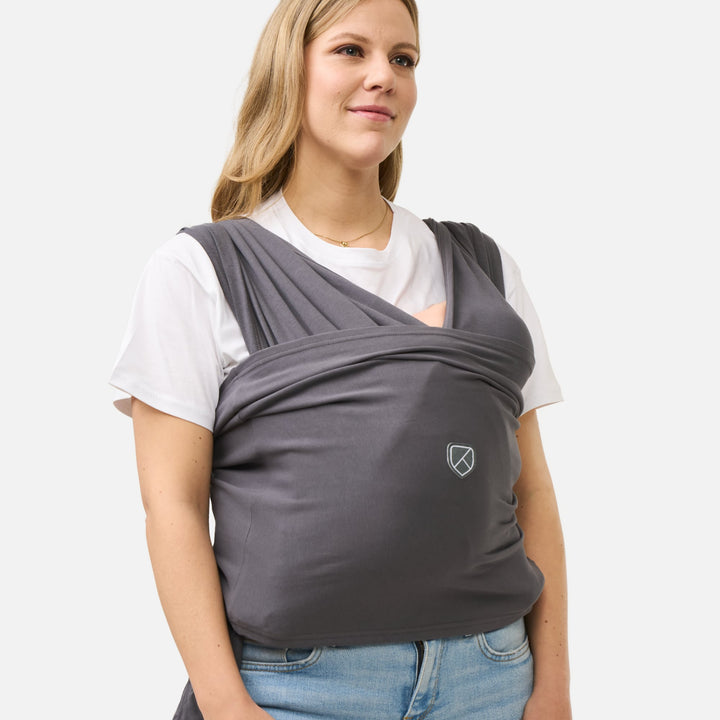 Side view of woman using Koala Babycare Cuddle Band 2 in dark gray for babywearing comfort and support