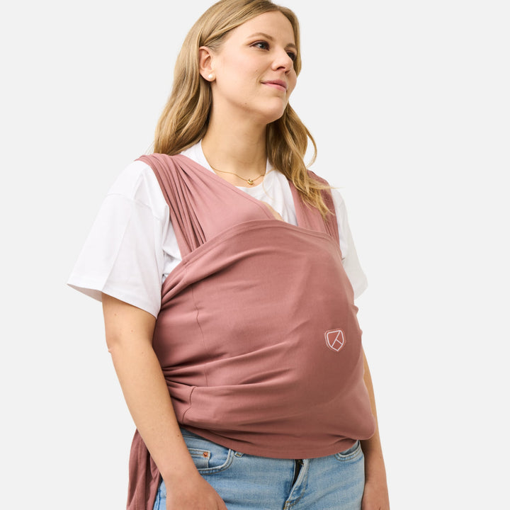 Soft and breathable Koala Babycare Koala Cuddle Band 2 baby wrap in earth red, perfect for hands-free babywearing.