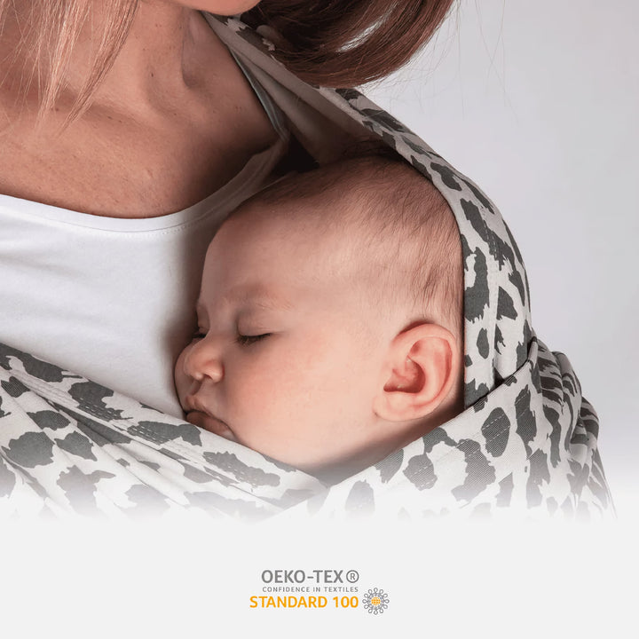 Close-up of sleeping baby in Koala Cuddle Band 2 with soft OEKO-TEX certified leopard print fabric