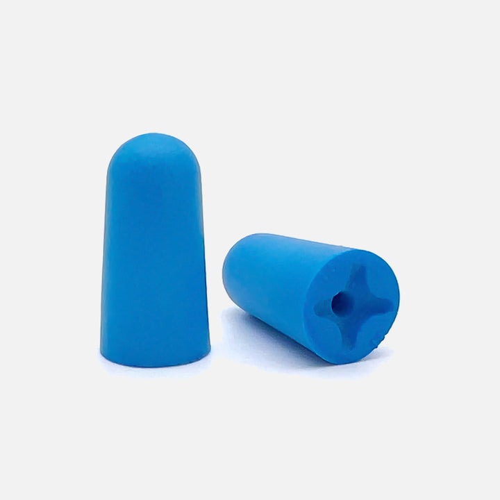 Close-up of Mack's Sound Asleep blue soft foam earplugs with hollow-end design for side sleeper comfort