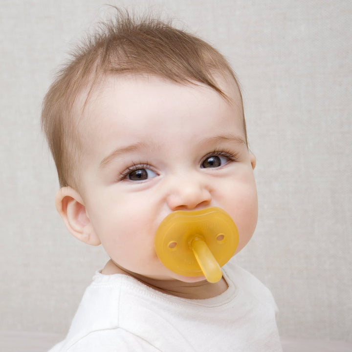 Baby using Natursutten Natural Rubber Butterfly Pacifier – soft, safe, and eco-friendly design for comfort and oral development.