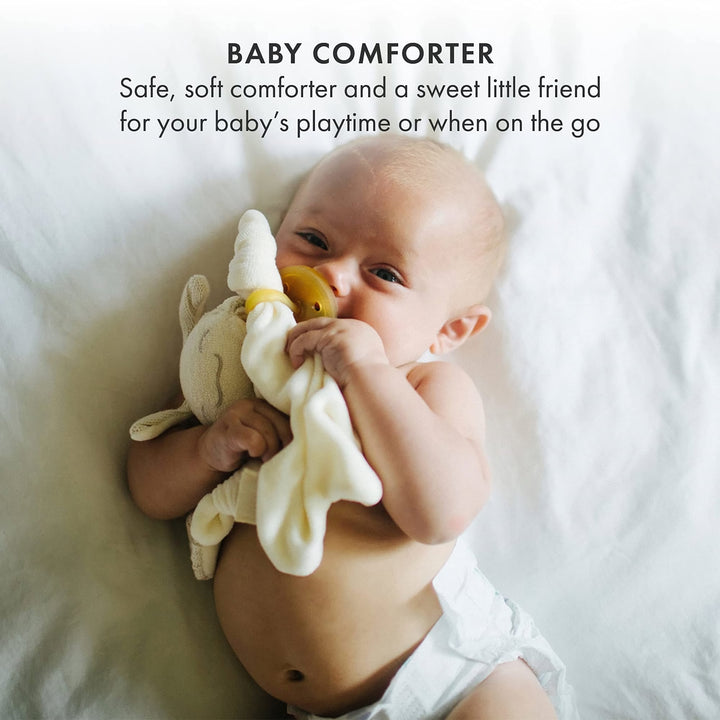 Baby holding Natursutten PaciPixy comforter with pacifier, a soft and safe companion for soothing and playtime