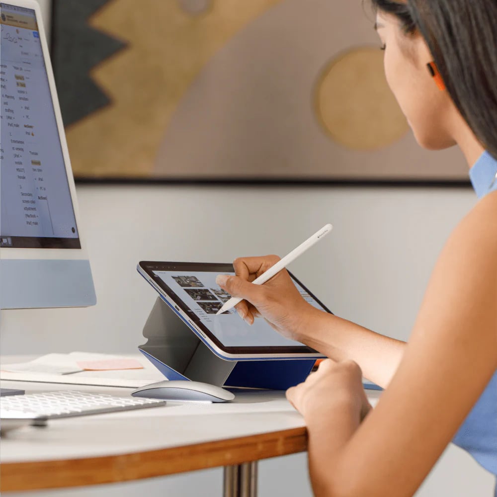 Person using MOFT Dynamic Folio with iPad and Apple Pencil at desk, showing ergonomic multi-angle stand for creative work