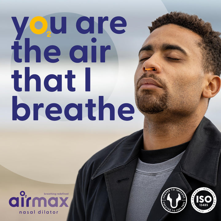 Man wearing an orange Airmax Nasal Dilator Classic, eyes closed, with brand logo and certification graphics