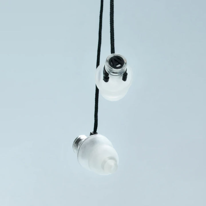 Close-up of Alpine Cord securely attached to earplugs for convenient wear