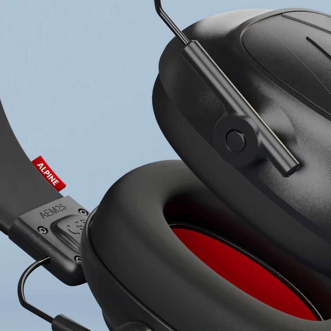 Close-up view of Alpine Defender earmuffs showing soft ear cushions and noise-reducing foam