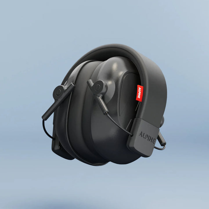 Folded Alpine Defender Earmuffs shown in compact travel size with black design on a light blue background