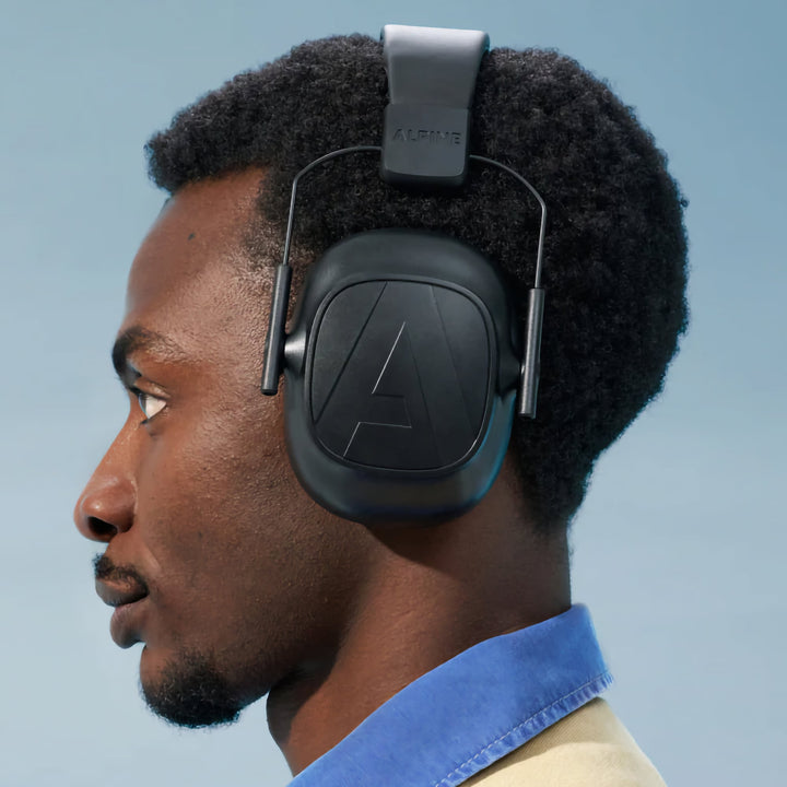 Man wearing Alpine Defender earmuffs for hearing protection with comfort and style