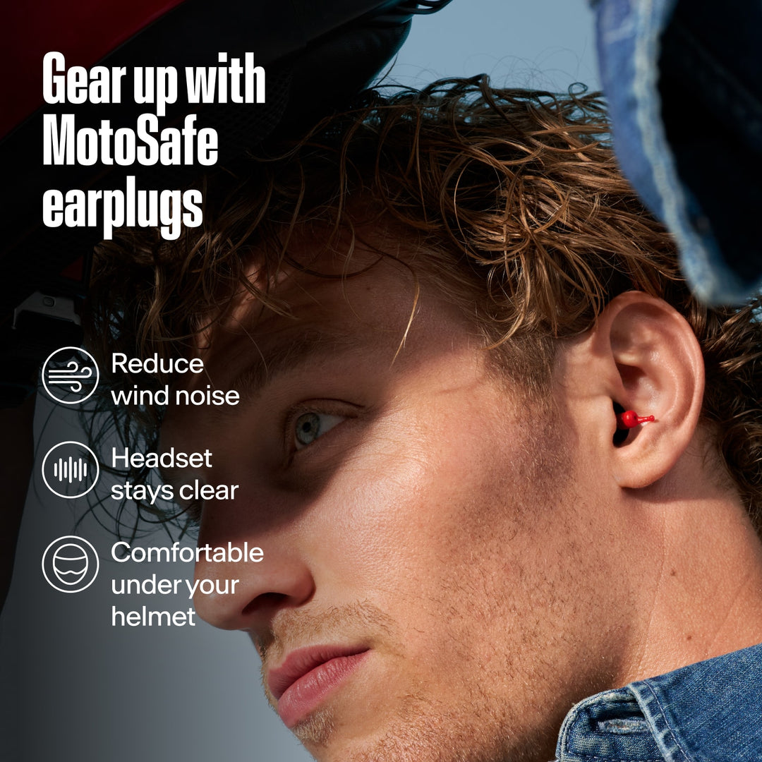 Red MotoSafe motorcycle earplug worn by a rider under a helmet, highlighting wind noise reduction