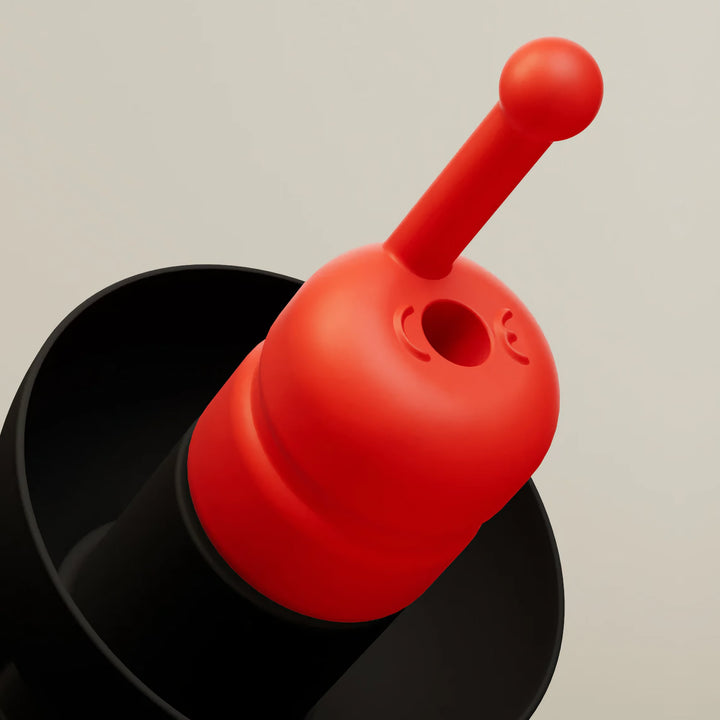 Alpine MotoSafe Race MotoGP earplug close-up showing red filter stem and black flange