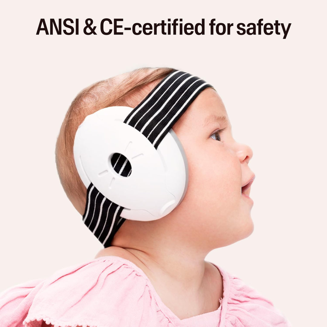Baby wearing Alpine Muffy Baby Classic black earmuffs with striped headband and safety certification text