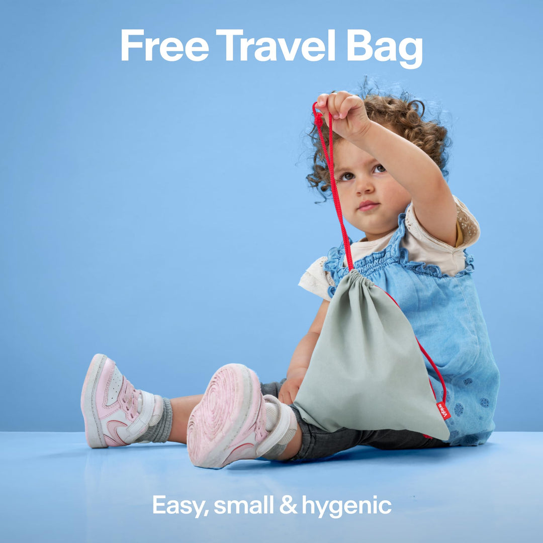 Child holding Alpine Muffy Baby travel pouch, showing included storage bag for earmuffs