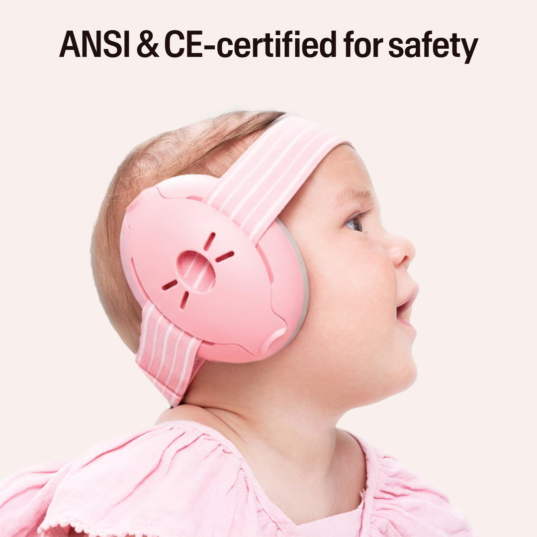 Baby wearing blush Alpine Muffy Baby earmuffs with ANSI and CE safety certification text