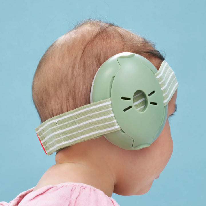 Rear side view of baby wearing Alpine Muffy Baby Earmuffs in green, featuring an adjustable, comfortable headband designed for effective noise protection.