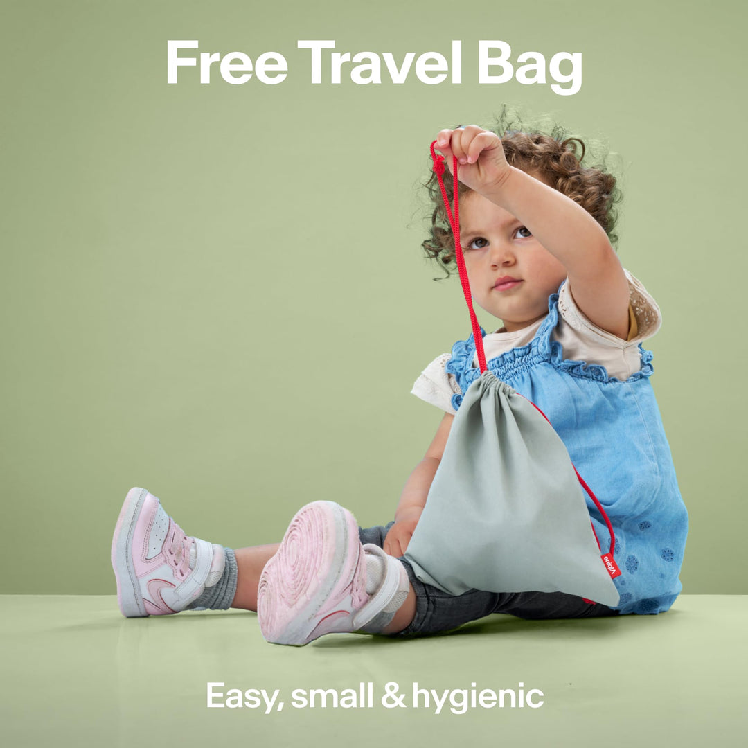 Child holding Alpine Muffy Baby travel pouch, showing included storage bag for earmuffs