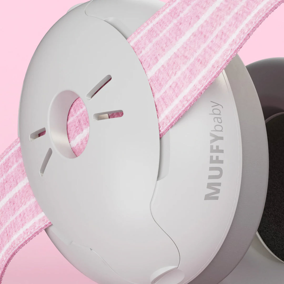 Close-up of Alpine Muffy Baby Earmuffs in pink, showing the durable ear cup design and adjustable non-slip headband for comfortable infant hearing protection.