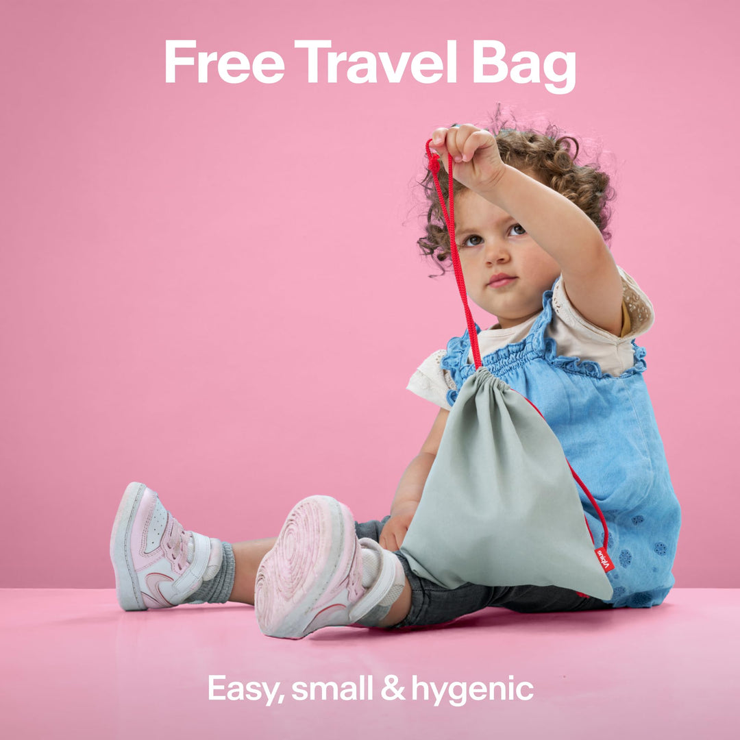 Child holding Alpine Muffy Baby travel pouch, showing included storage bag for earmuffs