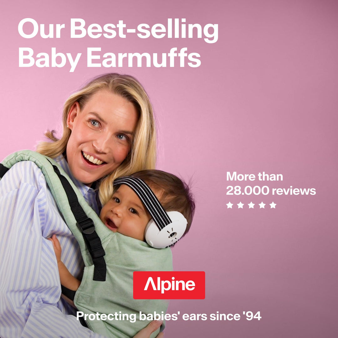 Parent carrying baby wearing white Alpine Muffy Baby Classic earmuffs with black striped headband