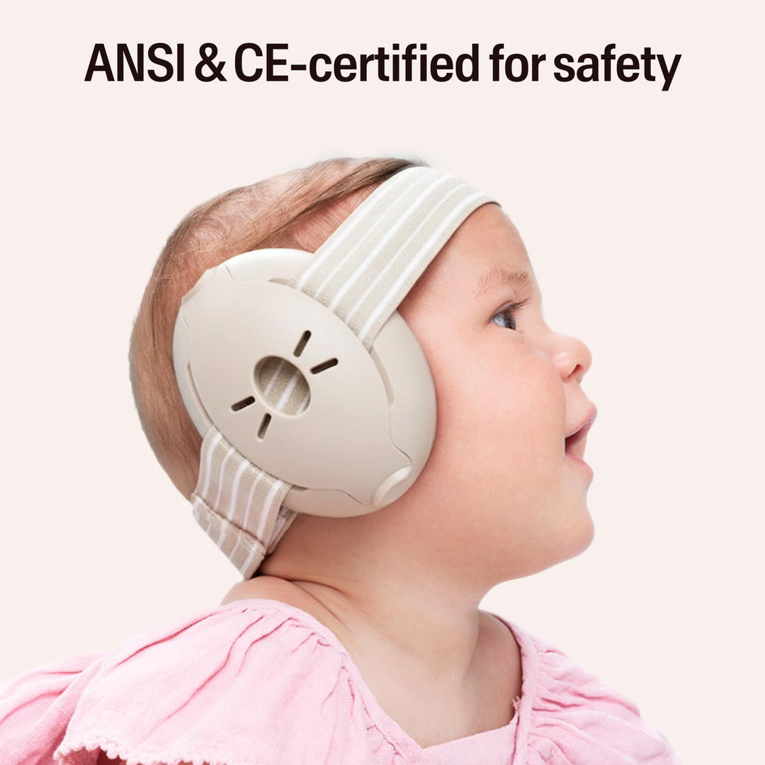 Baby wearing Alpine Muffy Baby Classic Sand earmuffs with striped headband and safety certification text