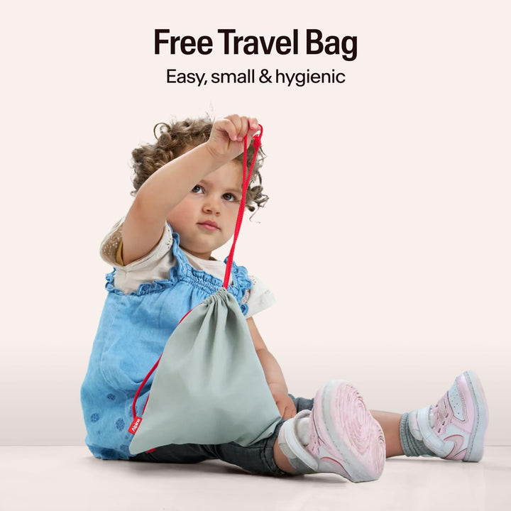 Child holding Alpine Muffy Baby travel bag with gray pouch and red drawstring in lifestyle scene