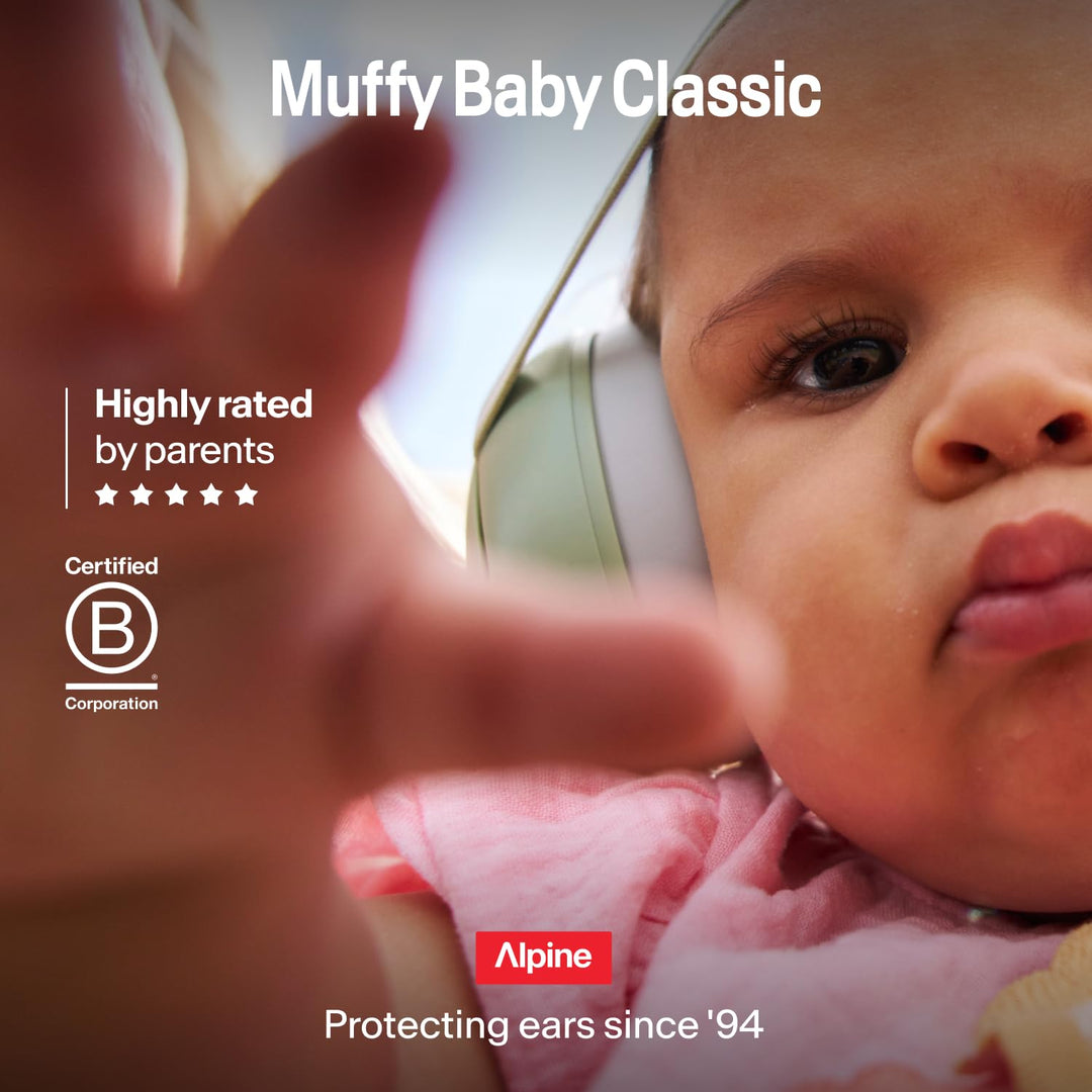 Close-up of baby wearing Alpine Muffy Baby Classic Sand earmuffs in outdoor lifestyle scene
