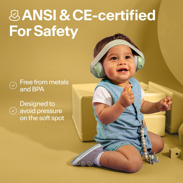 Toddler wearing Alpine Muffy Baby Classic yellow earmuffs with ANSI and CE safety certification information