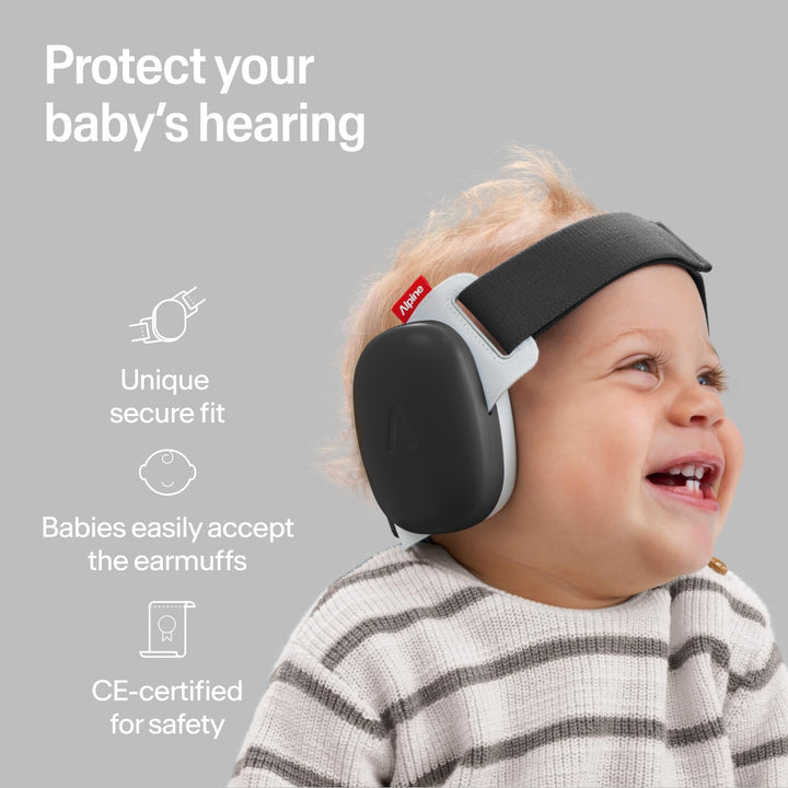 Baby wearing Alpine Muffy Baby Comfort Dusk Black earmuffs, highlighting the secure fit and hearing protection design