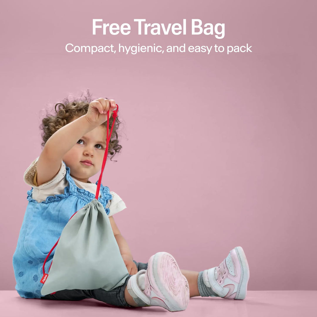 Child holding Alpine Muffy Baby Comfort earmuffs travel bag showing compact hygienic storage pouch for baby earmuffs