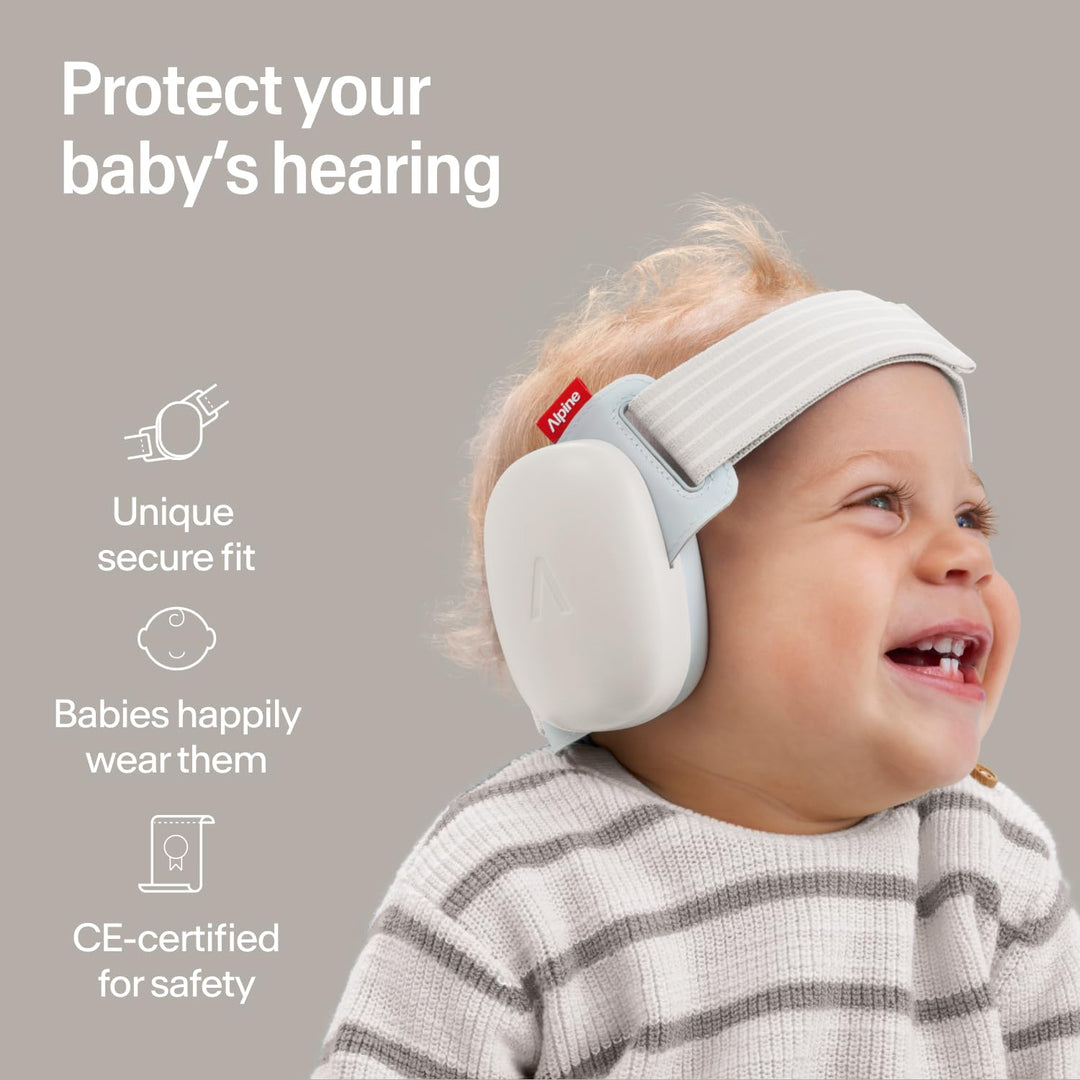Baby wearing Alpine Muffy Baby Comfort earmuffs Soft Sand showing secure fit soft headband and infant hearing protection