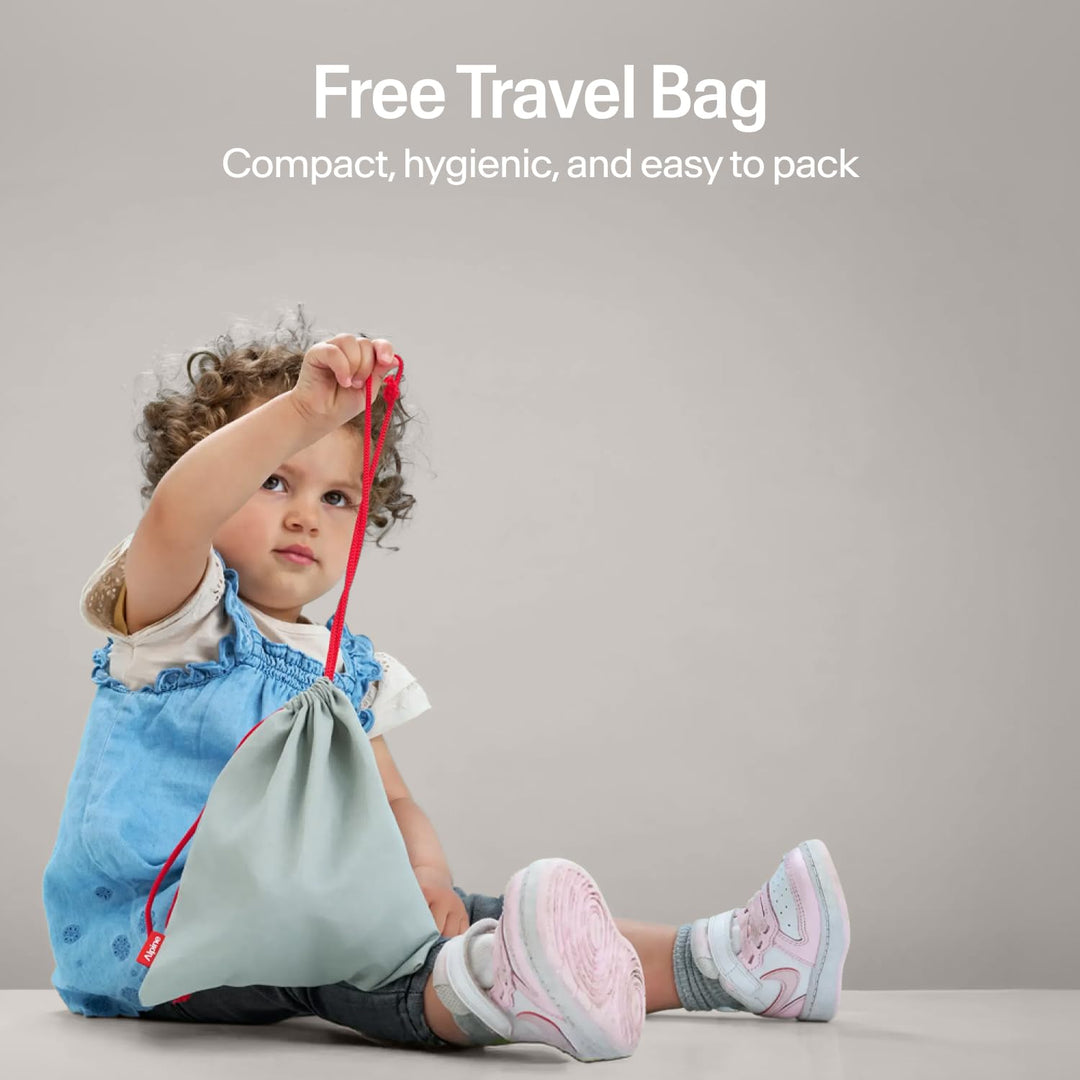 Child holding Alpine Muffy Baby Comfort earmuffs travel bag showing compact hygienic storage pouch for baby earmuffs