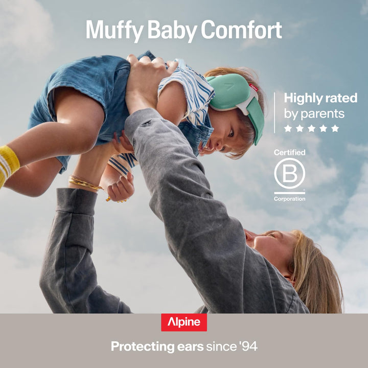 Parent lifting baby wearing Alpine Muffy Baby Comfort earmuffs showing comfortable infant hearing protection highly rated by parents