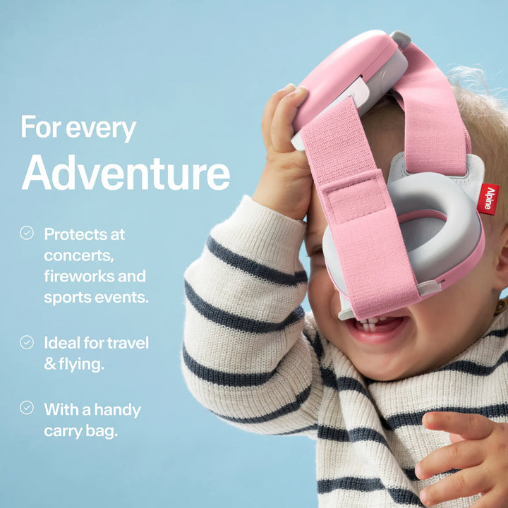 Baby playing with Alpine Muffy Baby Rose Pink earmuffs, ideal for concerts, fireworks, sports, travel, and safe adventures