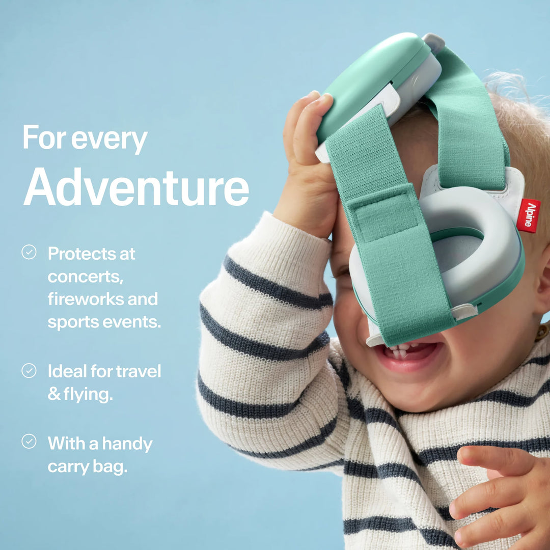 Baby playing with Alpine Muffy Baby sage green earmuffs, ideal for concerts, fireworks, sports, travel, and safe adventures